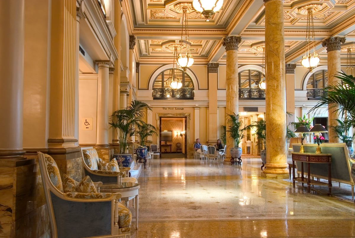 A luxurious hotel lobby interior with elegant architecture and warm welcoming ambiance